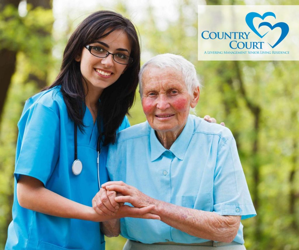 nurse with elderly resident enjoying the outdoors