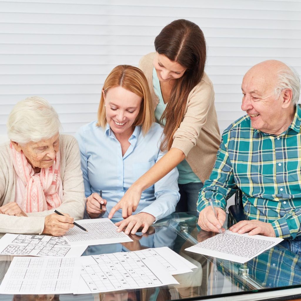 4 people working on crossword puzzles
